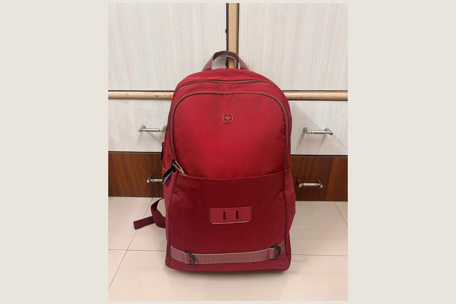 Representative photograph of a red zip-up backpack.