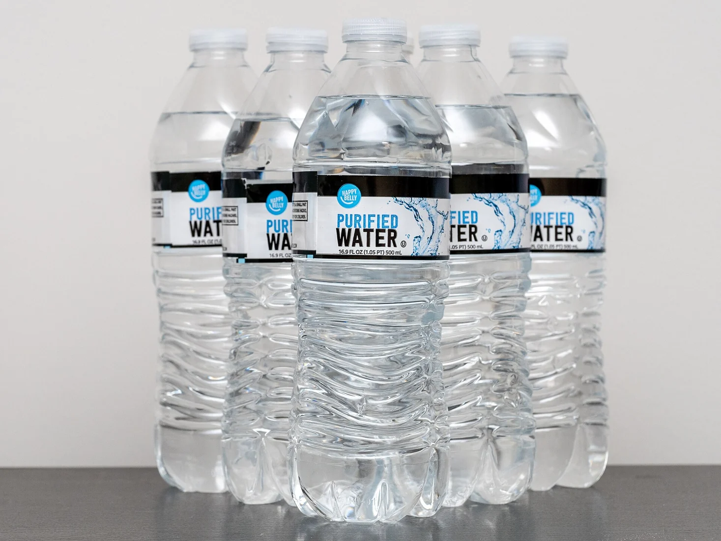 A group of sealed plastic drinking-water bottles.